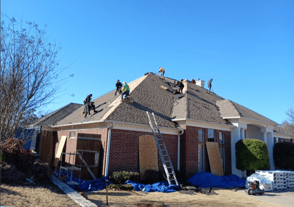 Shiva Strong Roofing crew replacing a residential roof in DFW